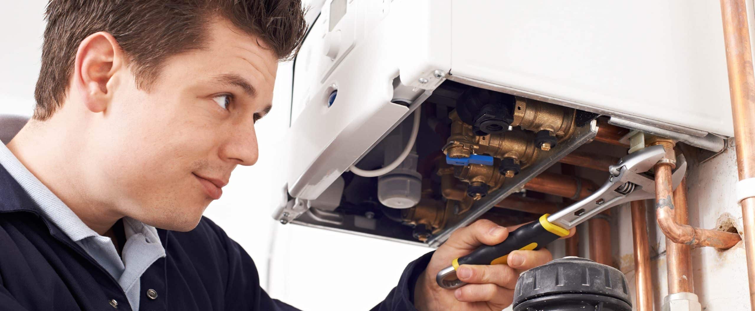 man looking at boiler